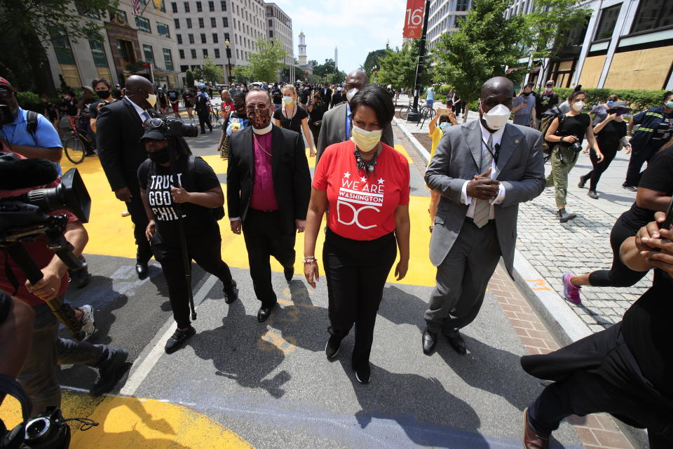 District of Columbia Mayor Muriel Bowser walks on the street leading to the White House after the words Black Lives Matter were painted in enormous bright yellow letters on the street by city workers and activists Friday, June 5, 2020, in Washington. (AP Photo/Manuel Balce Ceneta)