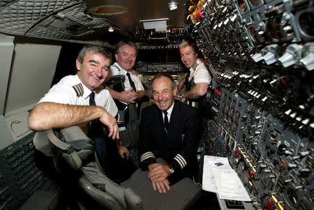 FILE PHOTO: The flight crew of the last British Airways passenger Concorde flight, (L-R) Engineering Officer (E.O.) David Hoyle, Captain Mike Bannister, E.O. Robert Woodcock and Captain Jonathan Napier, pose for a photograph before take-off at JFK Airport in New York, U.S., October 24, 2003. REUTERS/Stringer/File Photo