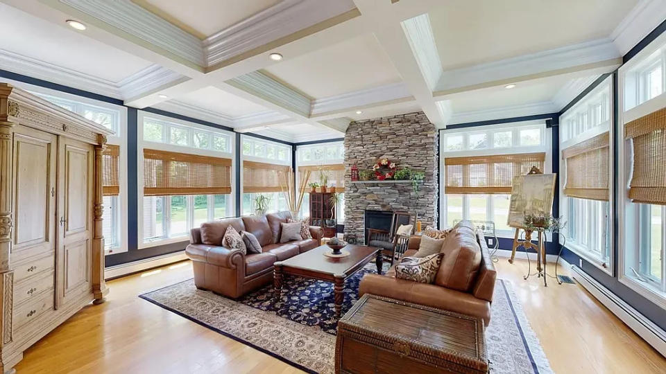 This home at 25 Sarah Drive in Bridgewater that sold for $869,900 on Aug. 29, 2023, has coffered ceilings, floor-to-ceiling glass walls and a stone gas fireplace.