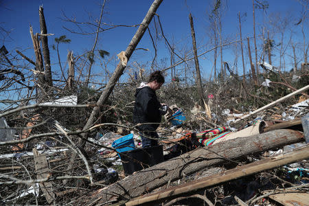 Barbara Roan looks for belongings from her destroyed trailer home after two deadly back-to-back tornadoes, in Beauregard, Alabama, U.S., March 5, 2019. REUTERS/Shannon Stapleton