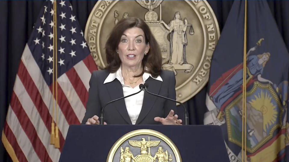 New York Governor Kathy Hochul stands at a podium as she makes an announcement about a mask mandate.