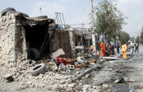 Afghan municipality workers clear debris after an explosion in Kabul, Afghanistan, Wednesday, Sept. 9, 2020. Spokesman for Afghanistan's Interior Ministry said the bombing that targeted the convoy of the country's first vice president on Wednesday morning killed several people and wounded more than a dozen others, including several of the vice president's bodyguards. (AP Photo/Rahmat Gul)