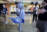 Cosplay artist Sisu Squid (2nd L) watches broadcasters during The International Dota 2 Championships at Key Arena in Seattle, Washington August 8, 2015. REUTERS/Jason Redmond