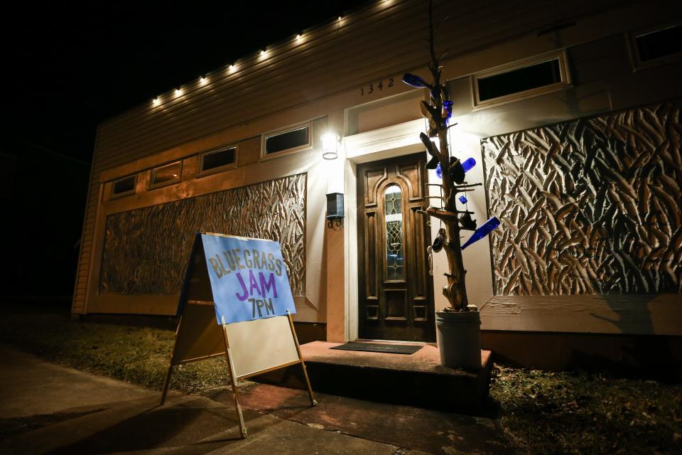 A hand-made sign stands outside of The Shoe Tree Listening Room, advertising a Bluegrass Jam, on Thursday, Feb. 8, 2024. Shoe Tree is the "performance art division" of Arrow Creative Reuse, an arts and crafts thrift store.