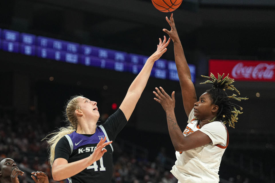 Texas forward DeYona Gaston shoots over Kansas State center Taylor Lauterbach during their Dec. 31 game at Moody Center. Gaston has moved away from a more traditional center's role on the team to out more on the perimeter, where she's been able to produce more offensively.