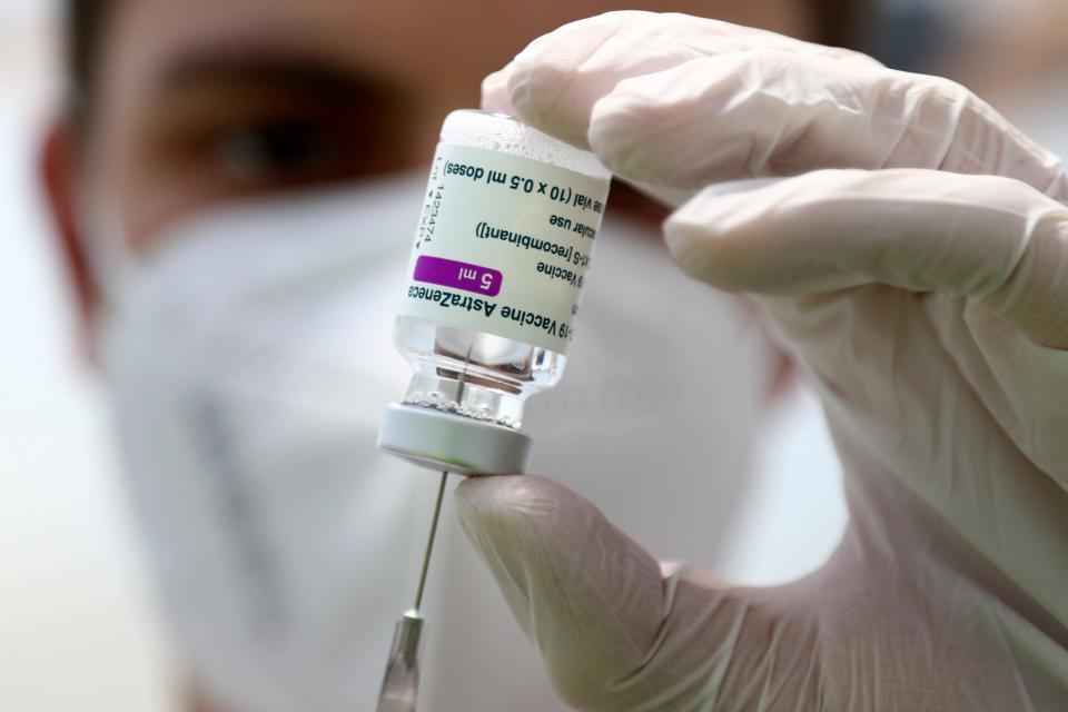 Medical staff prepares a syringe from a vial of the AstraZeneca coronavirus vaccine during preparations at the vaccine center in Ebersberg near Munich, Germany, Monday, March 22, 2021.