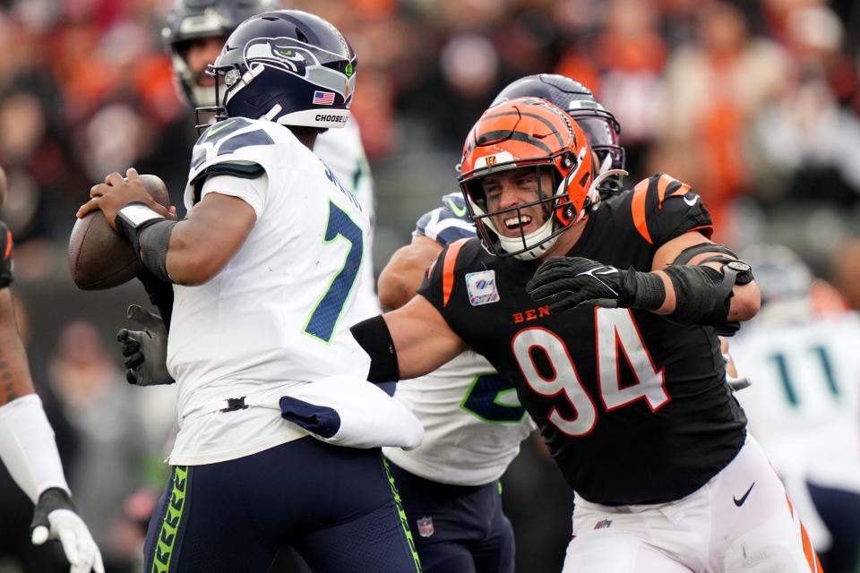 Cincinnati Bengals defensive end Sam Hubbard (94) pressures Seattle Seahawks quarterback Geno Smith (7) in the fourth quarter during an NFL football game between the Seattle Seahawks and the Cincinnati Bengals Sunday, Oct. 15, 2023, at Paycor Stadium in Cincinnati. The Cincinnati Bengals won, 17-13.