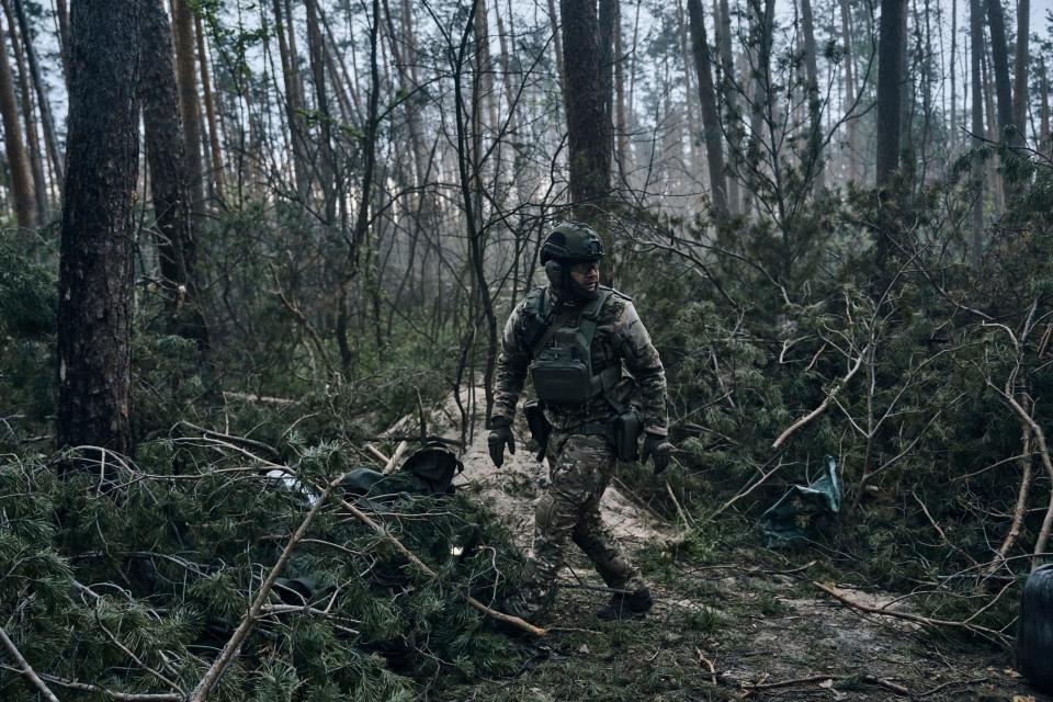 A Ukrainian soldier walks through the forest close to the Russian positions near Kremenna in the Luhansk region, Ukraine, Tuesday, May 9, 2023.
