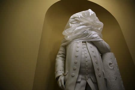 The statue of U.S. founding father Benjamin Franklin is covered with plastic during construction in an empty hallway outside the U.S. Senate at the U.S. Capitol in Washington January 6, 2016. REUTERS/Jonathan Ernst