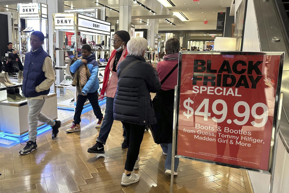 Black Friday shoppers walk through Macy's in Herald Square on Friday, Nov. 24, 2023, in New York. (AP Photo/Anne D'Innocenzio)