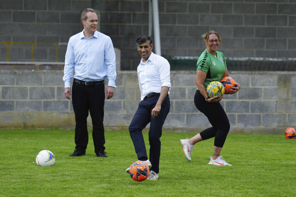 FILE - Britain's Prime Minister Rishi Sunak and David Johnston, Conservative Parliamentary Candidate for Didcot, Wantage & Wallingford, left, participate in football activities with a local school girls football team at Alfredian Park, home of Wantage Town Football Club, in Wantage, England, Monday June 3, 2024. Since announcing that the UK General Election will be held on July 4th, Rishi Sunak has visited key battleground regions across the UK. (Carl Court/Pool Photo via AP, File)