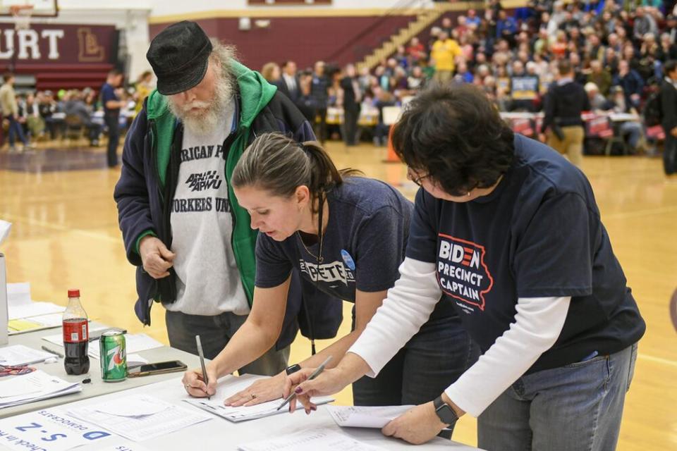 Precinct officials tally the votes during a caucus at Lincoln High School in Des Moines, Iowa, on Monday. | CRAIG LASSIG/EPA-EFE/Shutterstock