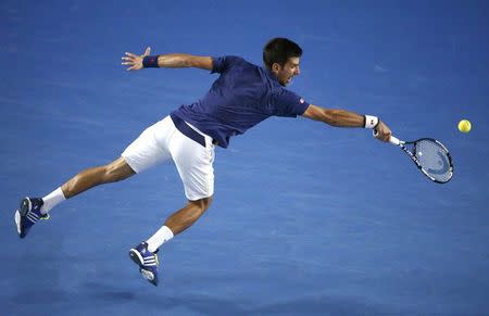 Serbia's Novak Djokovic stretches for a shot during his final match against Britain's Andy Murray at the Australian Open tennis tournament at Melbourne Park, Australia, January 31, 2016. REUTERS/Jason Reed TPX IMAGES OF THE DAY