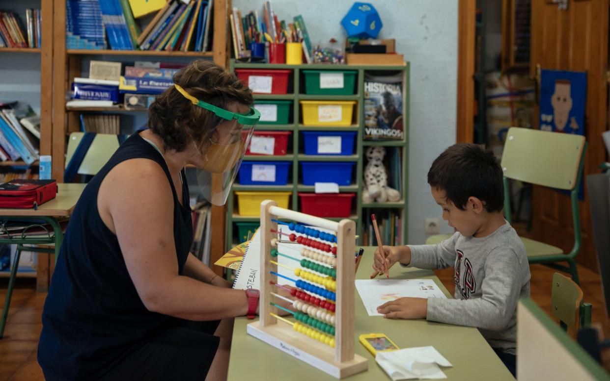  Patricia, gym teacher of Paules de Sarsa's school, studies with Angel in the classroom on September 11, 2020 in Paules de Sarsa, Spain. Angel is 4 years-old, in his first year at school. Paules de Sarsa's school, the smallest school in Aragon region, has five students between 4 to 12 years old. As students begin to return to school after a six-month shutdown, Spain became the first country in western Europe to reach half a million confirmed COVID-19 infections.  - Alvaro Calvo /Getty Images Europe 