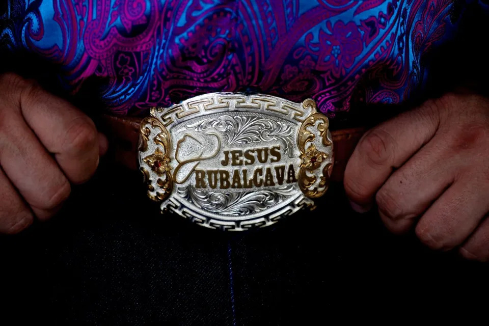 Jesus Rubalcava, 43, of Gila Bend, Arizona, displays his embossed belt buckle at a welcoming luncheon at Alicia Garden