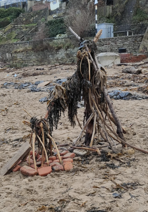 a creepy sculpture on a berach