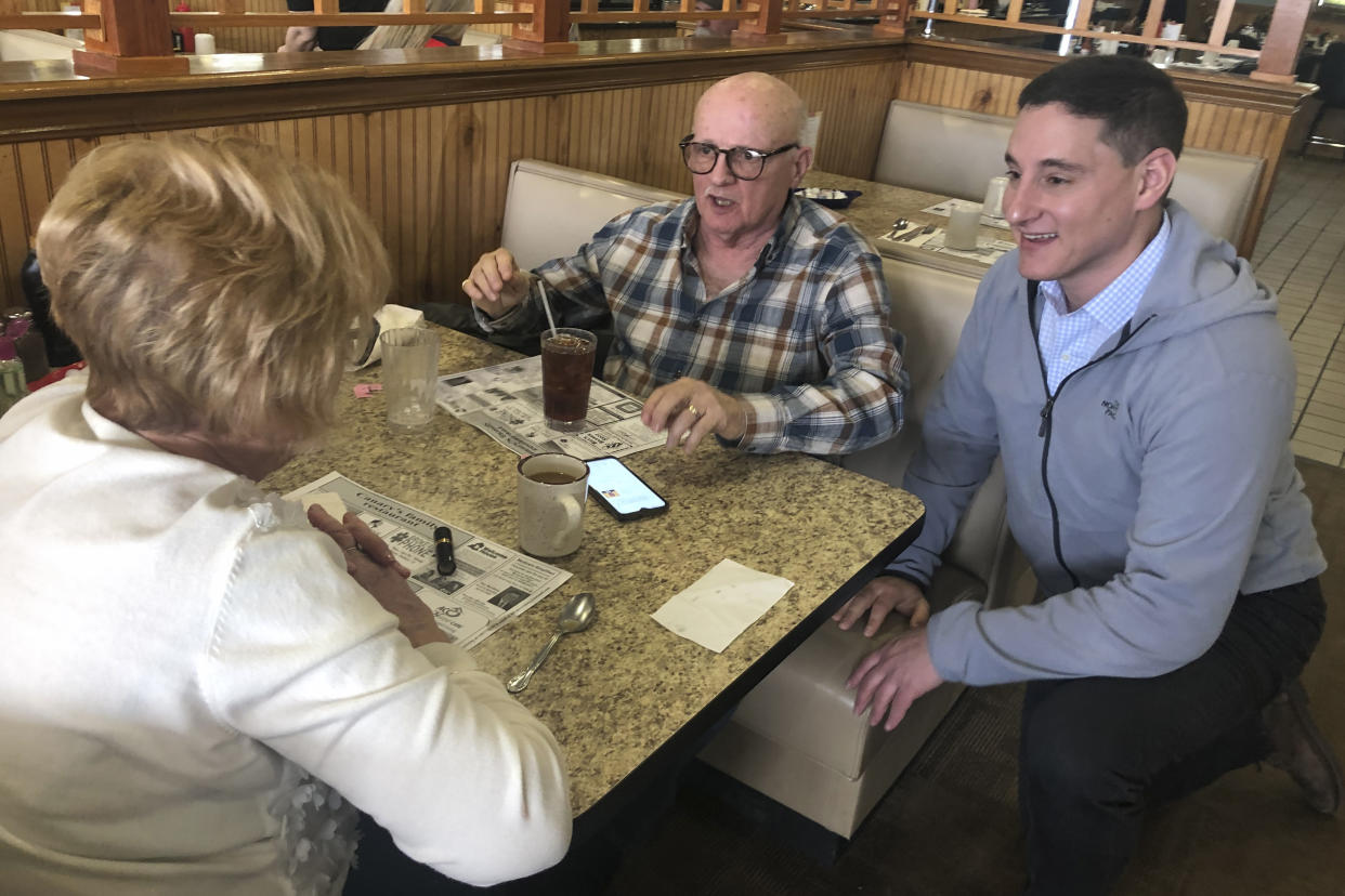 Republican Senate candidate Josh Mandel chats with Star and Bruce Clark at Canary's Family Restaurant in North Olmsted, Ohio, March 9, 2022. (AP Photo/Jill Colvin)