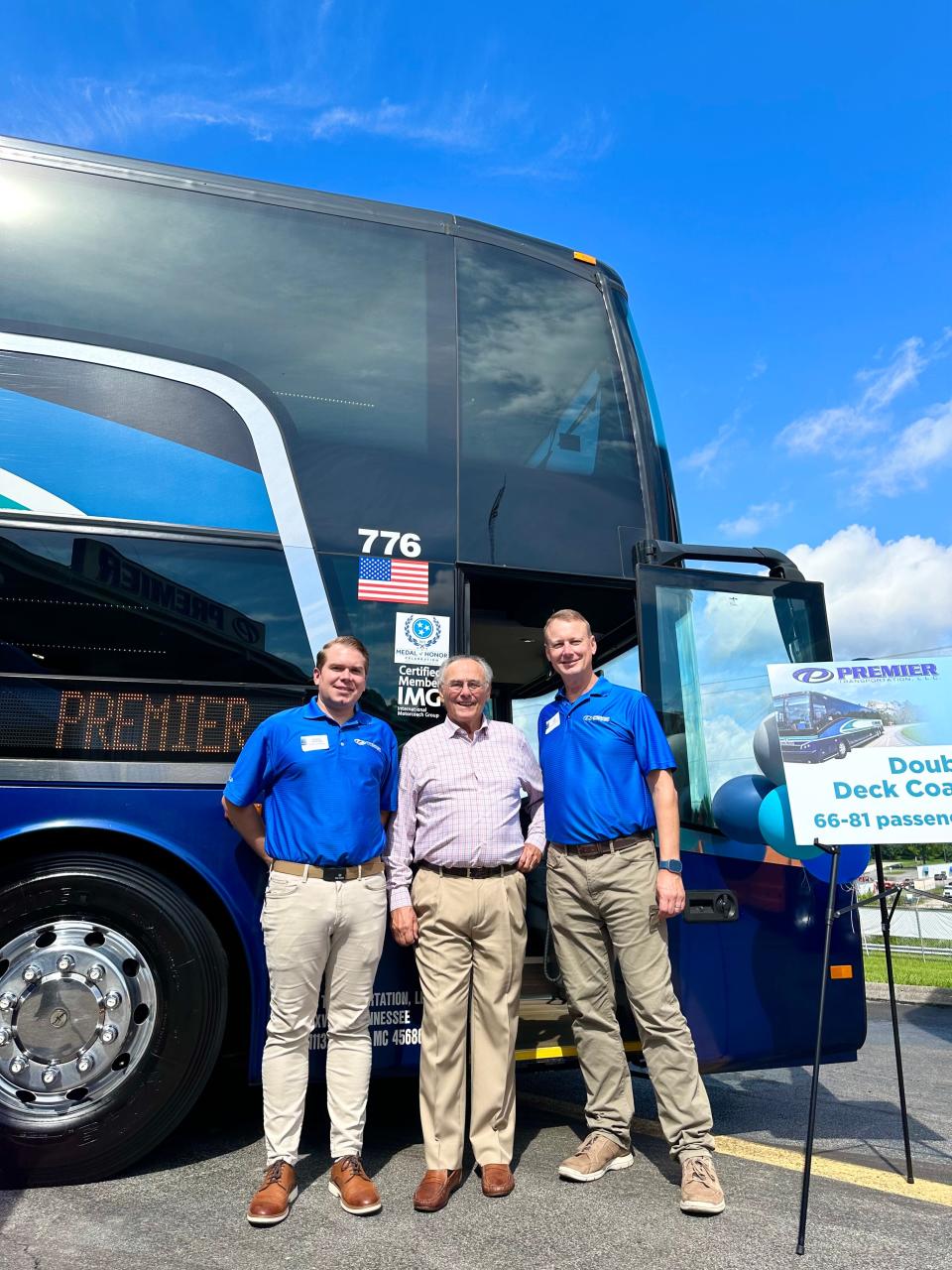 Taylor Thomas, Nick Cazana and Lee Arie of Premier Transportation stand in front of a double deck coach.