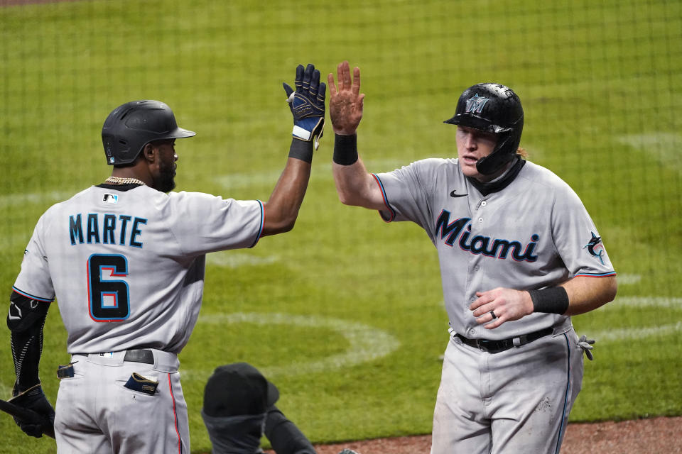 Miami Marlins' Chad Wallach celebrates with Starling Marte (6) after scoring on a Jon Berti double during the sixth inning of a baseball game against the Atlanta Braves on Thursday, Sept. 24, 2020, in Atlanta. (AP Photo/John Bazemore)