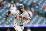 San Francisco Giants' Brandon Belt follows the flight of his two-run home run as he heads up the first-base line against the Colorado Rockies in the first inning of game two of a baseball doubleheader Tuesday, May 4, 2021, in Denver. (AP Photo/David Zalubowski)