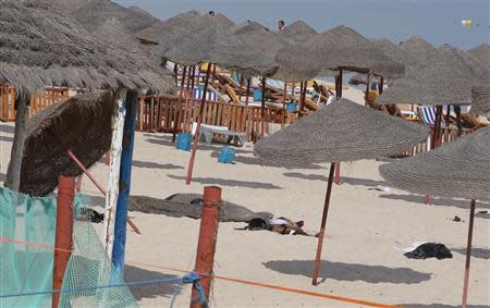 The corpse of a suicide bomber, who blew himself up, lies on a beach near the tourist resort of Sousse October 30, 2013. REUTERS/Mohamed Amine ben Aziza