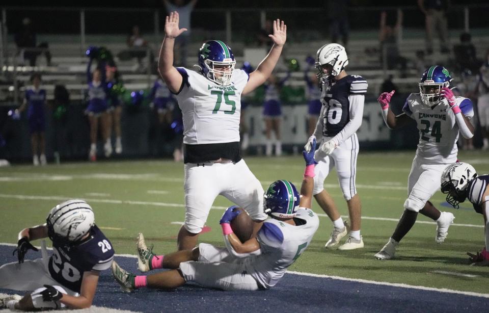 Ty Robbins (75) of Somerset Academy-Canyons in celebrates the touchdown of teammate David Duong (5) in the first half of a high school football game between American Heritage-Delray and Somerset Academy-Canyons on Friday, Oct. 10, 2022 in Delray Beach. 