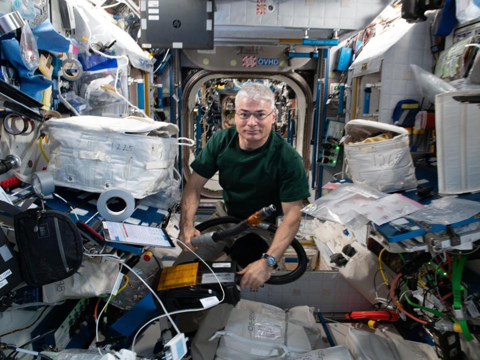 nasa astronaut mark vande hei floating inside international space station with supplies equipment