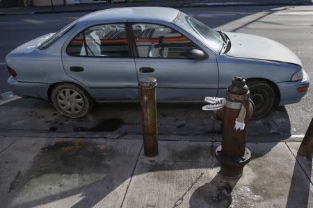 An automobile sits illegally parked without a parking ticket issued by the NYPD in the Queens borough of New York January 7, 2015. REUTERS/Shannon Stapleton