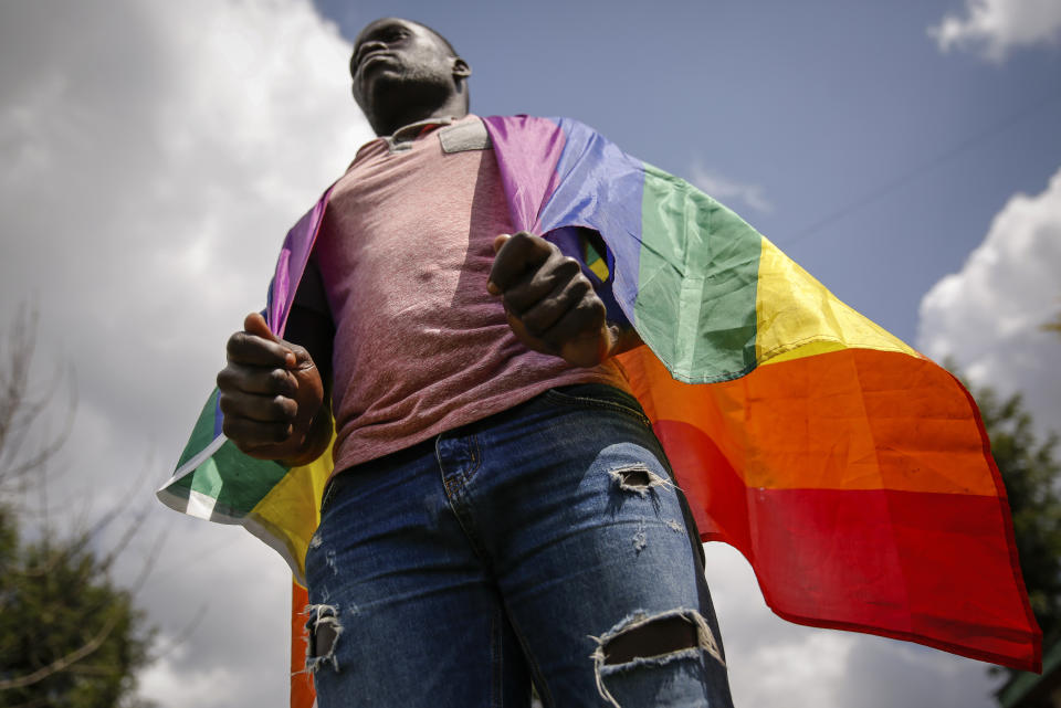 In this photo taken Thursday, June 11, 2020, Ugandan gay refugee Martin Okello poses for a photo outside the house he shares with other LGBT refugees in Nairobi, Kenya. Okello faced discrimination and violence that forced him to flee Uganda for Kenya to seek asylum and protection under the U.N. refugee agency. (AP Photo/Brian Inganga)