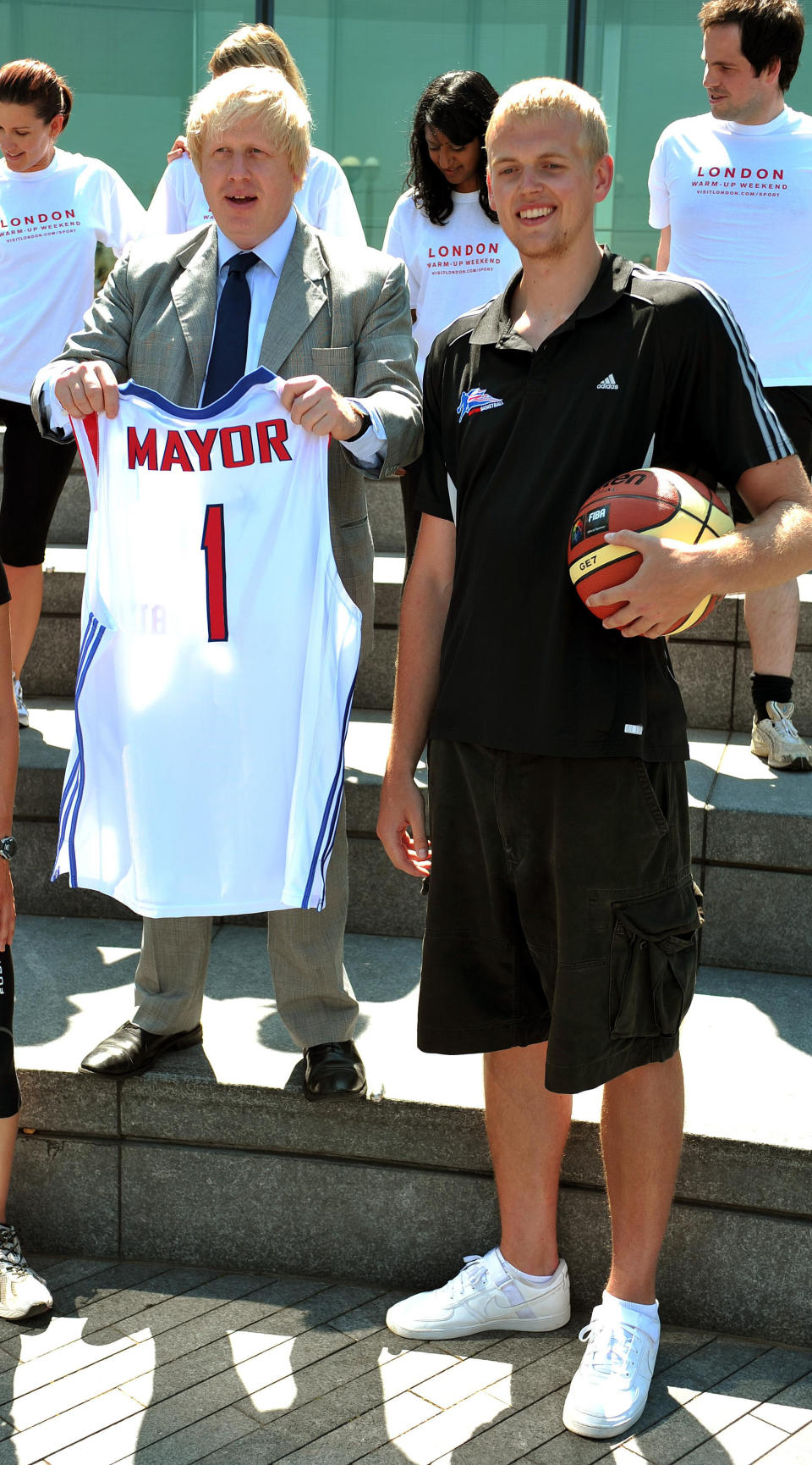 The Mayor of London Boris Johnson stands with basketball player Daniel Clark, during a photocall to promote 'warm up weekend', to get Londoners in the mood for the 2012 London Olympics, outside City hall in central London, this afternoon.