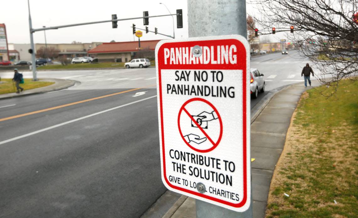 A city street sign posted on Kennewick Avenue near Highway 395, an area frequented by homeless panhandlers, encourages motorists to support local charities instead of directly donating to people on street corners.