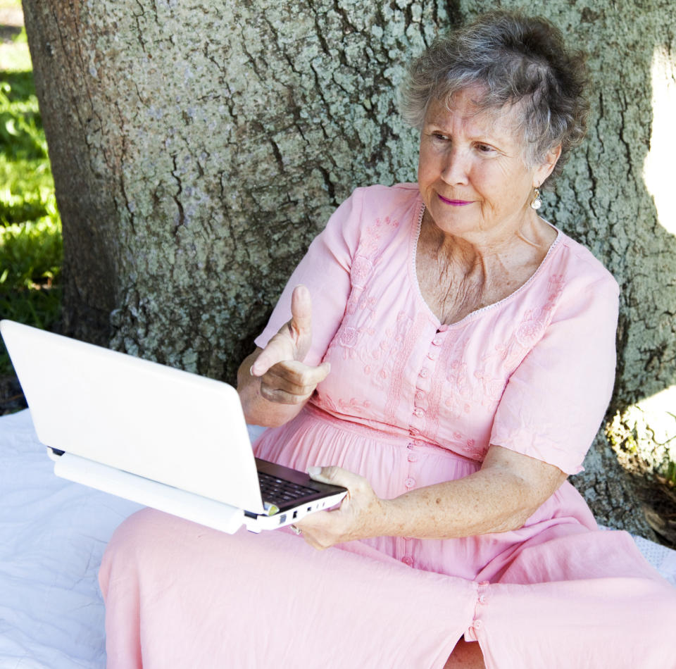 old lady using a computer getting angry at it