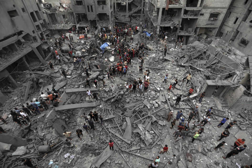 Palestinians inspect the damage of destroyed buildings following Israeli airstrikes on Gaza City, Friday, Oct. 27, 2023. (AP Photo/Abed Khaled)