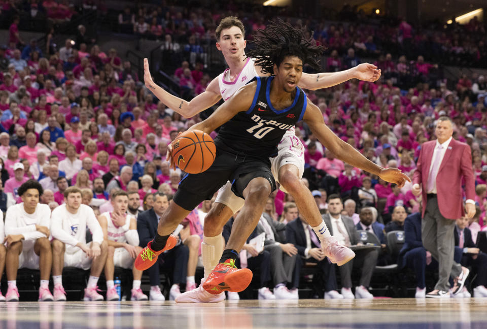 DePaul's Jaden Henley, front, drives past Creighton's Mason Miller during the first half of an NCAA college basketball game Saturday, Jan. 27, 2024, in Omaha, Neb. (AP Photo/Rebecca S. Gratz)