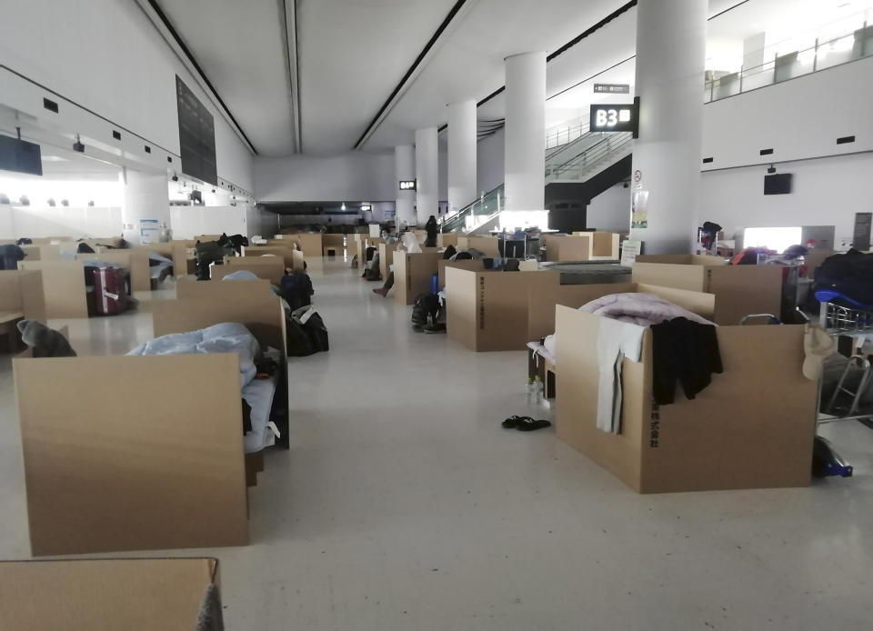 The scene at Narita airport, Japan, on April 8, 2020, where cardboard encampments are placed with social distancing to cater for people who have to wait for the results of a government coronavirus quarantine checks. Shotaro Tajima, a Japanese Health Ministry official in the contagious diseases section, said people are now at nearby hotels and have not had to stay in the boxes. If cases grow, people may need to wait longer for test results, which usually come back within several hours. (Yuri Kageyama via AP)