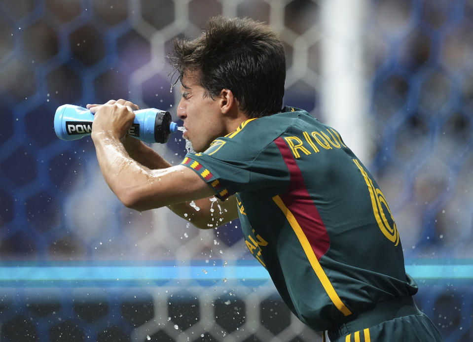 Los Angeles Galaxy's Riqui Puig takes a drink of water during the second half of the team's MLS soccer match against the Vancouver Whitecaps on Saturday, July 15, 2023, in Vancouver, British Columbia. (Darryl Dyck/The Canadian Press via AP)