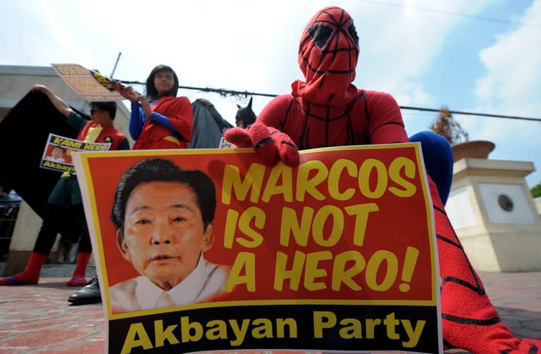 Activists are pictured on April 18, 2011 during a protest against a hero's burial for late dictator Ferdinand Marcos in Manila. Philippine President Benigno Aquino signed a landmark law on Monday compensating people who were tortured, raped or detained by Marcos's security forces during his 20-year rule