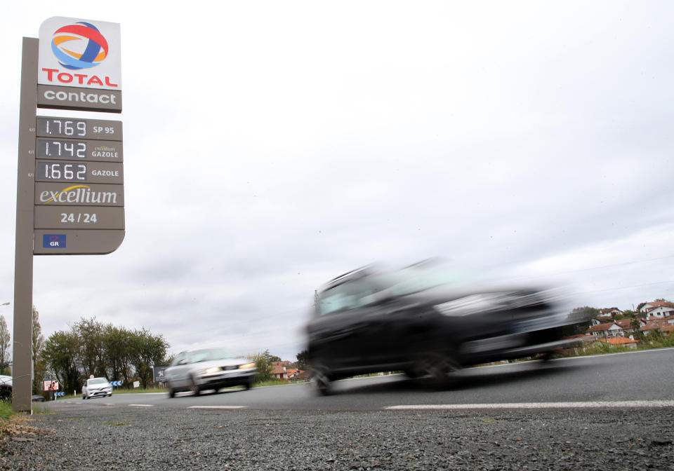 FILE - Cars pass by a gas station in Saint Jean de Luz, southwestern France, Friday, Oct. 22, 2021. When they gather for their first post-pandemic summit, leaders of the Group of 20 countries will confront a global recovery that's encountering unexpectedly persistent headwinds: A global energy crunch bringing higher fuel and utility prices, allegedly temporary consumer inflation that might hang around longer than first thought, and bottlenecks in supply chains that keep the global economy humming and goods headed to customers. (AP Photo/Bob Edme, File)