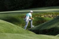 Jon Rahm of Spain chooses not to use the bridge to the 13th green during first round play of the 2018 Masters golf tournament at the Augusta National Golf Club in Augusta, Georgia, U.S., April 5, 2018. REUTERS/Mike Segar