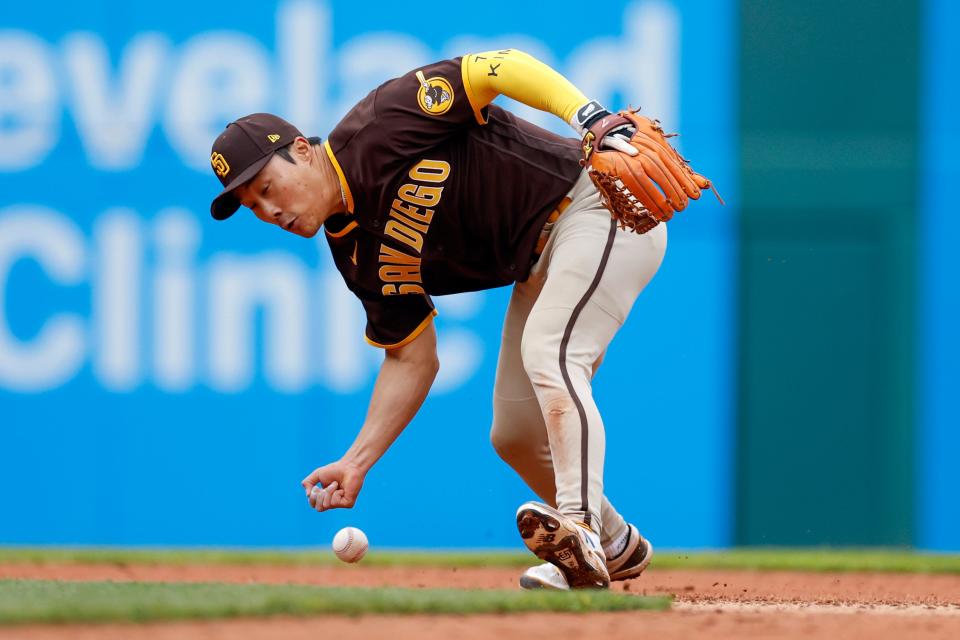 San Diego Padres' Ha-Seong Kim attempts to make a bare handed play on a single by Cleveland Guardians' Owen Miller during the seventh inning in the first baseball game of a doubleheader, Wednesday, May 4, 2022, in Cleveland. (AP Photo/Ron Schwane)