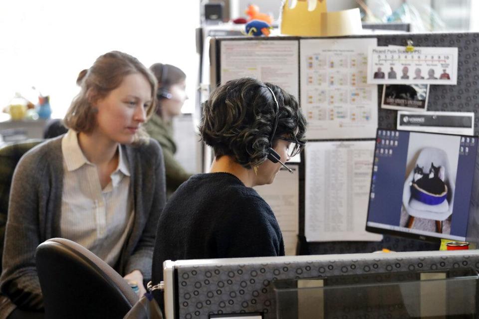 Public health nurse Jennifer Morgan, right, checks-in via phone with a patient self-quarantined at home who had some risk of exposure to the coronavirus as University of Washington epidemiology student Erika Feutz observes at the public health agency for Seattle and King County on Feb. 13. Washington state now has about 700 people focused on tracing contacts, with plans to expand the workforce to 1,500 by the second week of May.