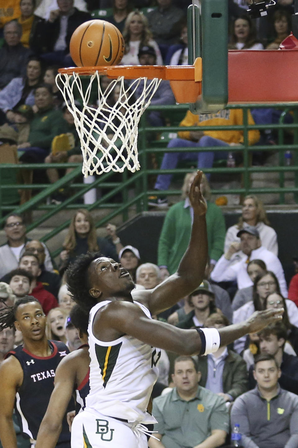 FILE - Baylor forward Jonathan Tchamwa Tchatchoua scores against Texas Tech in the second half of an NCAA college basketball game, Saturday, Feb. 4, 2023, in Waco, Texas. Tchamwa Tchatchoua sees himself as a “walking miracle” after getting back on the court for 14th-ranked Baylor nearly a full year after a gruesome knee injury that many people thought would end his career. (AP Photo/Rod Aydelotte, File)