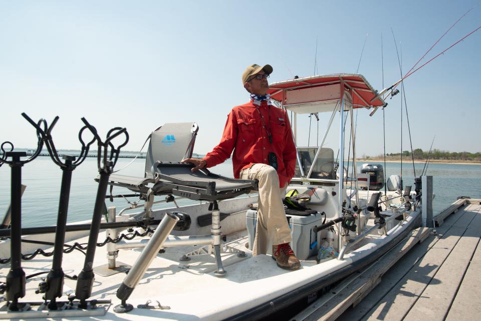 Joe Bragg stands on his bay boat Tuesday after touring portions of Milford Lake fishing for crappie.