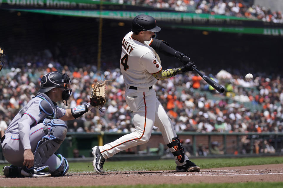 San Francisco Giants' Patrick Bailey, right, hits a home run in front of Miami Marlins catcher Nick Fortes during the second inning of a baseball game in San Francisco, Sunday, May 21, 2023. (AP Photo/Jeff Chiu)