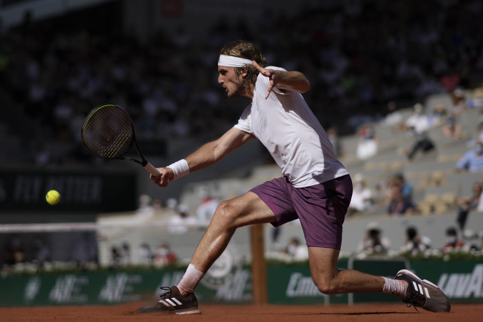 Stefanos Tsitsipas of Greece returns the ball to Germany's Alexander Zverev during their semifinal match of the French Open tennis tournament at the Roland Garros stadium Friday, June 11, 2021 in Paris. (AP Photo/Christophe Ena)