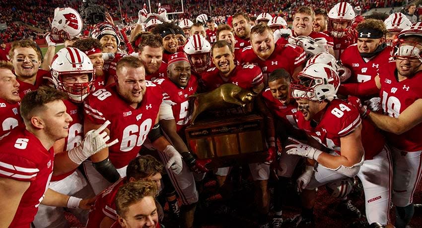 Nov 9, 2019; Madison, WI, USA; Wisconsin Badgers players celebrate with the Heartland Trophy following the game against the Iowa Hawkeyes at Camp Randall Stadium.