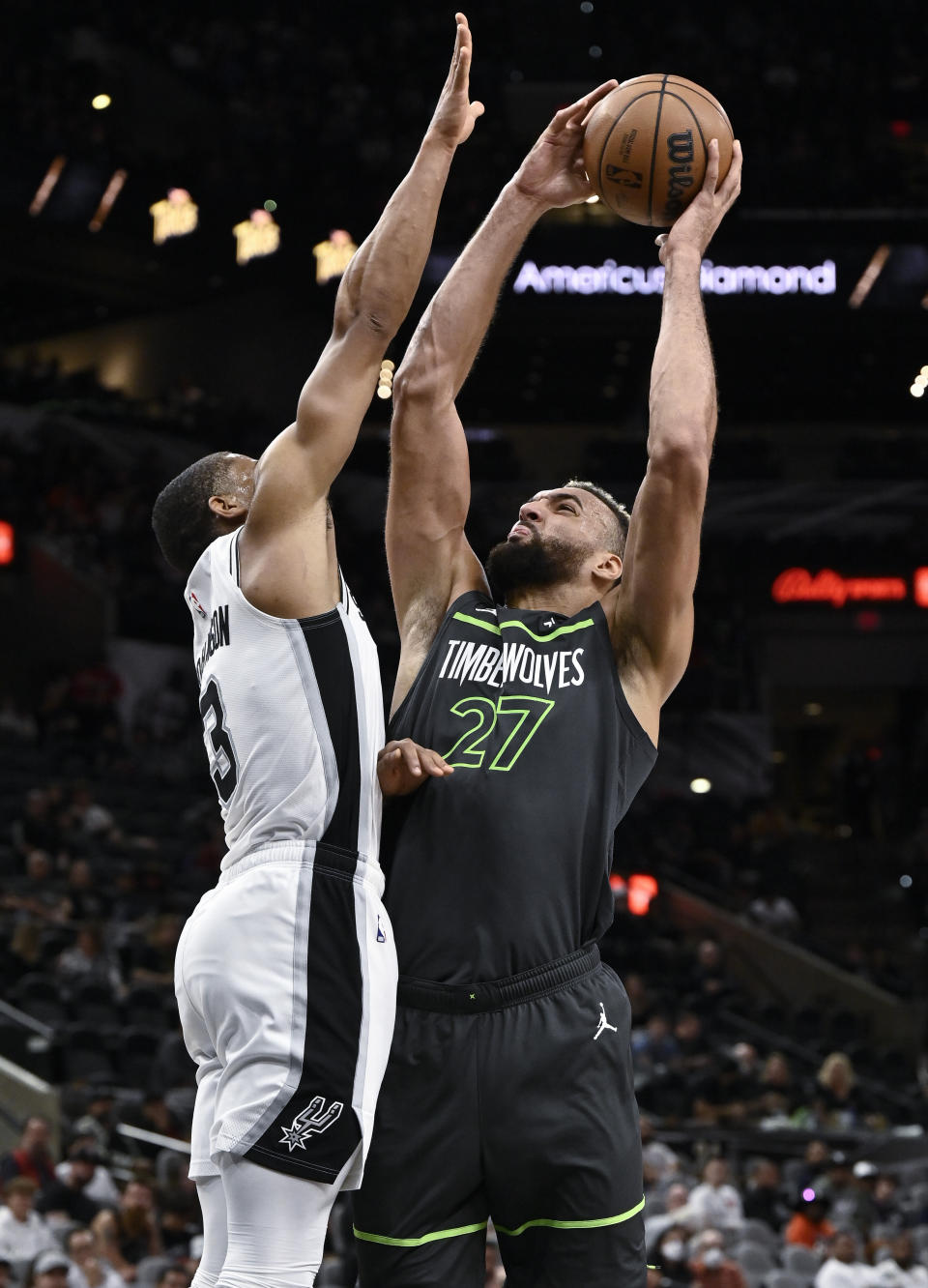 Minnesota Timberwolves' Rudy Gobert (27) attempts to shoot against San Antonio Spurs' Keldon Johnson during the first half of an NBA basketball game, Sunday, Oct. 30, 2022, in San Antonio. (AP Photo/Darren Abate)