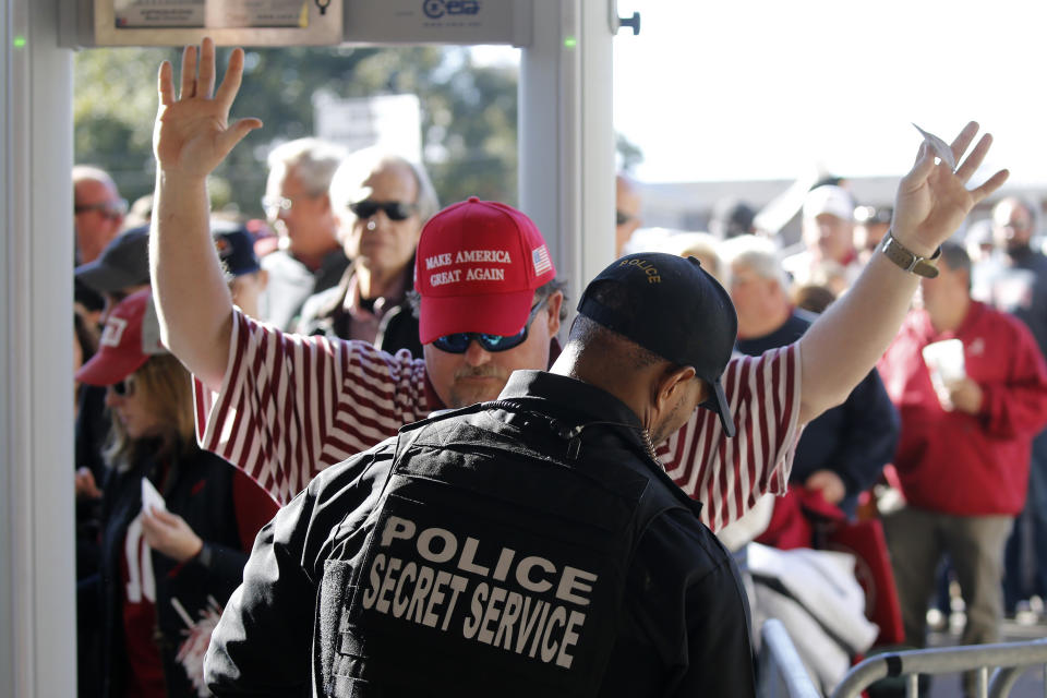 A fan entering Bryant Denny Stadium is checked for weapons by a uniformed Secret Service officer before an NCAA football game between Alabama and LSU Saturday, Nov. 9, 2019, in Tuscaloosa, Ala. Extra security was in place because President Donald Trump is expected to attend the game. (AP Photo/John Bazemore)