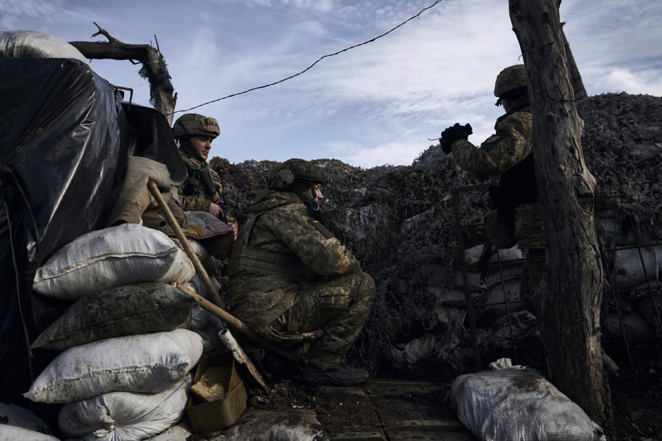 Ukrainian soldiers take position during fights with Russian forces near Maryinka, Donetsk region, Ukraine, Friday, Dec. 23, 2022. (AP Photo/Libkos)