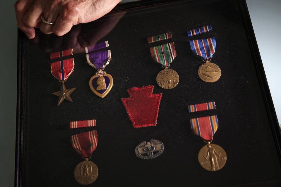 Medals earned during World War II by Sam Newey, 98. From left to right, top to bottom is the Bronze Star, Purple Heart, European-African-Middle Eastern Campaign Medal, American Campaign Medal, Army Good Conduct Medal, Army Combat Medical badge and the World War II Victory Medal. Center is his 28th Infantry Division patch.